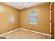 Bedroom featuring tan walls, plush carpet, and natural light from a window at 979 Walnut Creek Ln, Jonesboro, GA 30238