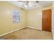 Bedroom featuring ceiling fan, plush carpet, and natural light from a window at 979 Walnut Creek Ln, Jonesboro, GA 30238