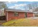 View of a brick house exterior with a window and sliding glass door, complemented by a lawn at 979 Walnut Creek Ln, Jonesboro, GA 30238