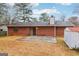Brick home exterior featuring a concrete patio and a sliding glass door leading to the backyard at 979 Walnut Creek Ln, Jonesboro, GA 30238
