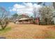 Quaint single-story brick home with a front porch, offering a welcoming curb appeal and surrounded by mature trees at 979 Walnut Creek Ln, Jonesboro, GA 30238