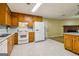 Traditional eat-in kitchen with wood cabinets and white appliances at 979 Walnut Creek Ln, Jonesboro, GA 30238