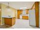 Open eat-in kitchen with wood cabinets, breakfast bar, and bright lighting at 979 Walnut Creek Ln, Jonesboro, GA 30238