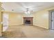 Inviting living room showcasing a brick fireplace, neutral walls, ceiling fan, and a sliding door for ample natural light at 979 Walnut Creek Ln, Jonesboro, GA 30238