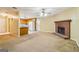 Open-concept living room with a brick fireplace, view of the kitchen, neutral walls, and comfortable carpeting at 979 Walnut Creek Ln, Jonesboro, GA 30238