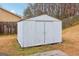 Backyard storage shed, providing extra storage space and functionality on a grassy lot at 979 Walnut Creek Ln, Jonesboro, GA 30238