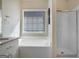 Bright bathroom featuring a soaking tub, granite countertops, and a glass-doored shower at 1421 Saint Charles Ct, Conyers, GA 30094