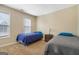 Bedroom with twin beds, carpeted floors, and white blinds filtering light through the windows at 1421 Saint Charles Ct, Conyers, GA 30094