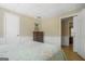 Bedroom with views into other rooms, light hardwood floors, and white wainscoting along the walls at 1421 Saint Charles Ct, Conyers, GA 30094