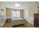 Bedroom with light hardwood floors, a ceiling light fixture, and white wainscoting along the walls at 1421 Saint Charles Ct, Conyers, GA 30094