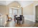 Bright dining room with vaulted ceiling, modern chandelier, and bay window with natural light at 1421 Saint Charles Ct, Conyers, GA 30094