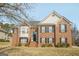 Charming two-story brick home featuring black shutters and a well-manicured front yard at 1421 Saint Charles Ct, Conyers, GA 30094