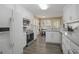 Bright kitchen with granite counters, stainless steel appliances, and white cabinets for storage at 1421 Saint Charles Ct, Conyers, GA 30094