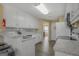 Well-lit kitchen with granite counters, stainless steel appliances, white cabinetry and gray backsplash at 1421 Saint Charles Ct, Conyers, GA 30094