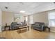 Cozy basement living room with neutral walls, laminate floors, sofas, and natural light at 1421 Saint Charles Ct, Conyers, GA 30094