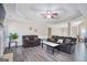 Inviting living room with trey ceiling, hardwood floors, ceiling fan, and comfortable sofas at 1421 Saint Charles Ct, Conyers, GA 30094