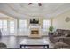 Elegant living room with fireplace, hardwood floors, trey ceiling, and ample natural light at 1421 Saint Charles Ct, Conyers, GA 30094