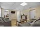 Living room with a light wood floor, grey sofas, and a mounted TV on the wall at 1421 Saint Charles Ct, Conyers, GA 30094