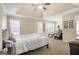 Main bedroom with carpet, ceiling fan, neutral walls, and natural light from two windows at 1421 Saint Charles Ct, Conyers, GA 30094