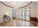 Elegant dining room with hardwood floors, chandelier, and wainscoting offering a great space at 9163 Retreat Pass, Jonesboro, GA 30236