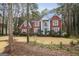 Charming red brick two-story home with mature landscaping, offering classic elegance and curb appeal at 9163 Retreat Pass, Jonesboro, GA 30236