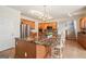 Kitchen featuring granite counters, stainless steel appliances, wood cabinets, and large center island with seating at 9163 Retreat Pass, Jonesboro, GA 30236