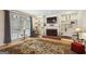 Comfortable living room with a cozy fireplace, built-in shelves, and a large window with natural light at 9163 Retreat Pass, Jonesboro, GA 30236