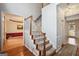 Inviting staircase with carpeted steps and wood railing, connecting the home's multiple levels at 9163 Retreat Pass, Jonesboro, GA 30236