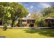 Exterior angle of house with a small backyard, shade trees, and established landscaping at 2791 Pearl St, East Point, GA 30344