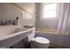 Bathroom featuring a classic sink, toilet, and tub with shower, offering functionality and practicality at 2791 Pearl St, East Point, GA 30344