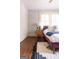 Bedroom featuring hardwood floors, natural light, a decorative rug, and a side table with decor at 2791 Pearl St, East Point, GA 30344