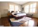 Stylish bedroom featuring hardwood floors, two windows and a cozy sitting bench at 2791 Pearl St, East Point, GA 30344