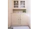 An elegant vintage hutch with glass-front cabinets adds charm and storage space at 2791 Pearl St, East Point, GA 30344