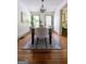 Bright dining room with hardwood floors and a stylish rug and adjacent sitting room adds charm and appeal at 2791 Pearl St, East Point, GA 30344