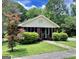 Charming brick home featuring a cozy front porch and lush landscaping at 2791 Pearl St, East Point, GA 30344