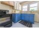 Charming kitchen with blue cabinets, contrasting countertops, and a black appliance at 2791 Pearl St, East Point, GA 30344