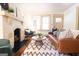 Inviting living room with a fireplace, plush seating, and a large rug at 2791 Pearl St, East Point, GA 30344