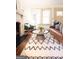 Bright living room with a brick fireplace, a stylish sofa, and a patterned rug at 2791 Pearl St, East Point, GA 30344