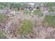 An aerial view showing residential homes nestled among trees, some with evergreen foliage, in a suburban setting at 220 Terrane Rdg, Peachtree City, GA 30269