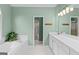 Clean bathroom featuring a soaking tub with tile surround, dual sinks, and a separate walk-in shower at 220 Terrane Rdg, Peachtree City, GA 30269