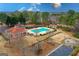 Aerial shot featuring a community pool area, clubhouse, playground, volleyball court, and surrounding green spaces at 220 Terrane Rdg, Peachtree City, GA 30269