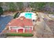 Aerial view highlights a community center with a pool, red mulch landscaping, and a seating area at 220 Terrane Rdg, Peachtree City, GA 30269