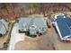Aerial view showcasing the home's facade, with well-maintained landscaping, a driveway, and a manicured lawn at 220 Terrane Rdg, Peachtree City, GA 30269