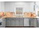 Updated kitchen featuring gray cabinets, granite countertops, and stainless steel appliances at 220 Terrane Rdg, Peachtree City, GA 30269