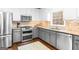 Well-lit kitchen features stainless steel appliances, granite countertops and ample cabinet space at 220 Terrane Rdg, Peachtree City, GA 30269