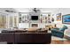 Comfortable living room with built-in bookshelves, a fireplace, a leather sofa, and a cozy atmosphere for relaxation at 220 Terrane Rdg, Peachtree City, GA 30269