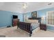 Spacious main bedroom with a calming blue color, ceiling fan, and two bedside tables at 220 Terrane Rdg, Peachtree City, GA 30269