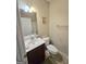 Cozy bathroom featuring a vanity with a sink, decorative mirror, and toilet at 4605 Irish Red Ct, Union City, GA 30291