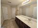 Bathroom featuring a vanity with a sink, a large mirror, and decorative shelving at 4605 Irish Red Ct, Union City, GA 30291