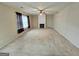 Carpeted living room with a decorative fireplace, ceiling fan, and natural light from curtained windows at 4605 Irish Red Ct, Union City, GA 30291